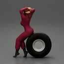 2 Models - SEXY GIRL MECHANIC IN SUIT SITTING ON A TRUCK TYRE AND HANDS IN HAIR - Only-Games