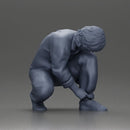 Worker injumpsuit Squatting Down, Carefully Adjusting His Pants with Focus - Only-Games