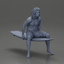 Long-Haired Surfer Sitting on a Surfboard in Calm Ocean Waters, Waiting for the Waves - Only-Games