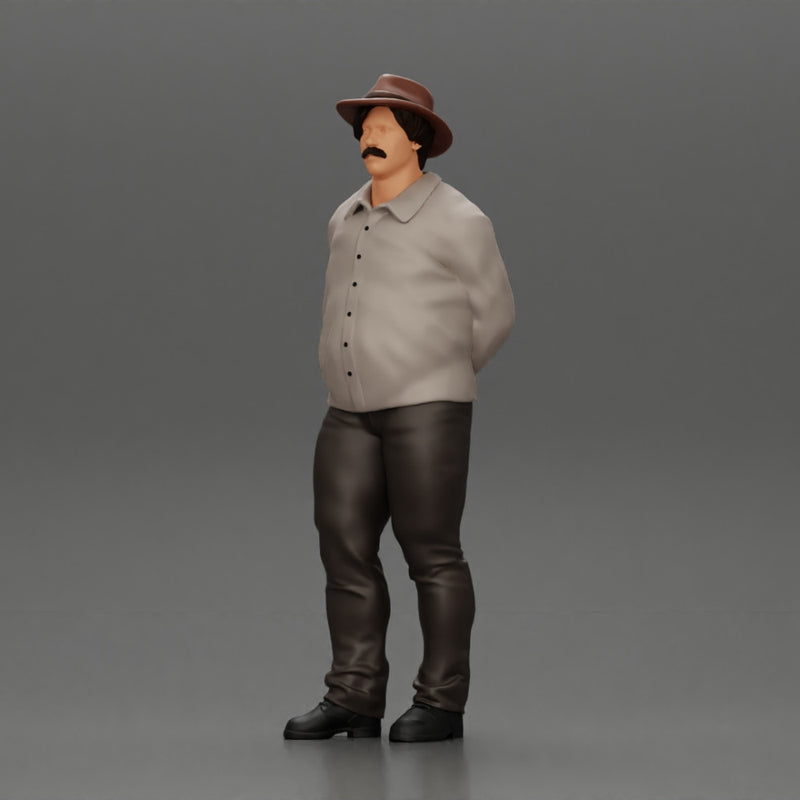 Man in a hat putting hands behind his back ( pablo escobar )