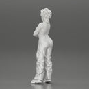 A chola girl with curly hair standing in large pants with crossed hands - Only-Games