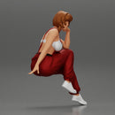 young woman sitting taking off her bib overalls - Only-Games