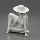 young woman in a summer suit and hat sitting - Only-Games