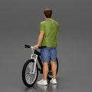 Young Man Standing In The Forest Posing Proudly With His Bike - Only-Games