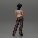 A chola girl with curly hair standing in large pants with crossed hands - Only-Games