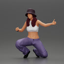 Young girl wearing a hat and pants sitting holding a sign and hitchhiking - Only-Games