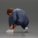 Worker injumpsuit Squatting Down, Carefully Adjusting His Pants with Focus - Only-Games