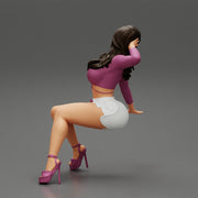Young sexy girl in shorts with long hair is sitting with one hand in hair - Only-Games