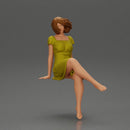 beautiful girl in dress sitting outside with her short hair blowing in the wind - Only-Games