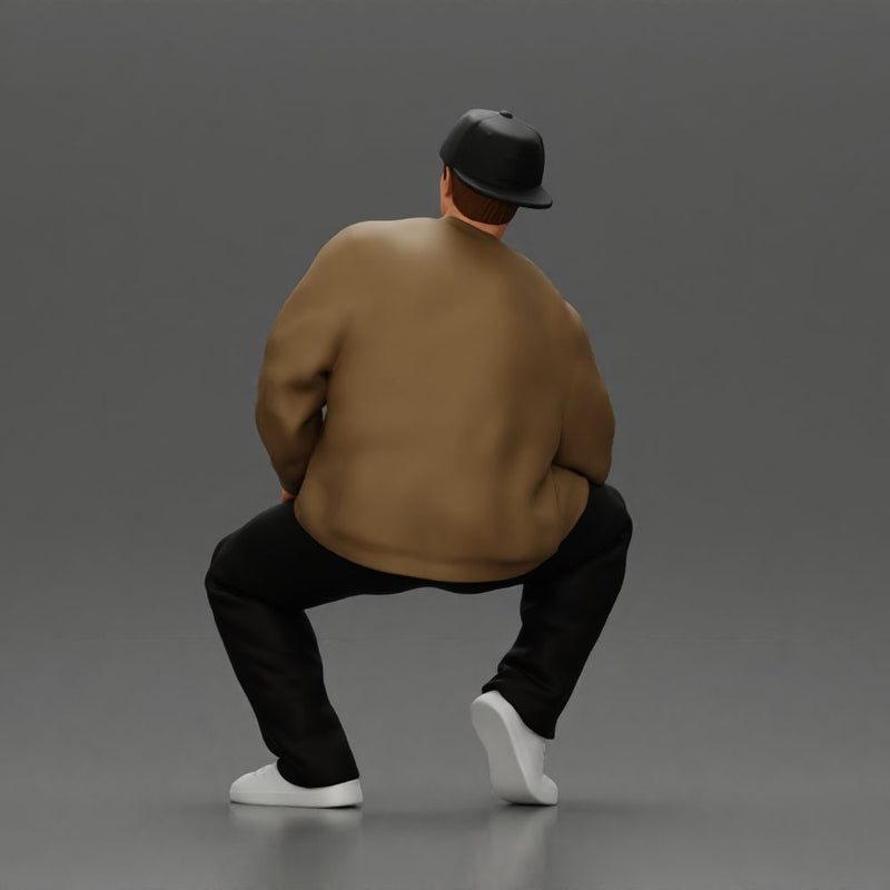 hip hop man sitting in a jacket and cap