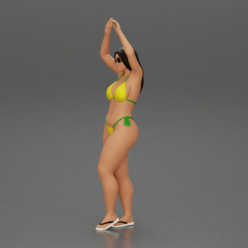 beautiful woman in a bikini with sunglasses standing with her arms raised up on the beach - Only-Games