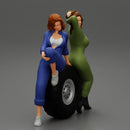 Two sexy girls in mechanic suits are sitting on a truck tire - Only-Games