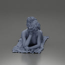 Relaxing on a beach towel, a woman enjoys sunbathing, wrapped in a pareo beach cover and bikini - Only-Games