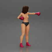 black naked breasts woman in boxing gloves with curly hair ready to finish off her opponent - Only-Games