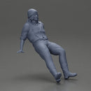 Man in Vintage Outfit and bonnet Seated in a Relaxed Pose - Only-Games