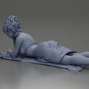 Relaxing on a beach towel, a woman enjoys sunbathing, wrapped in a pareo beach cover and bikini - Only-Games