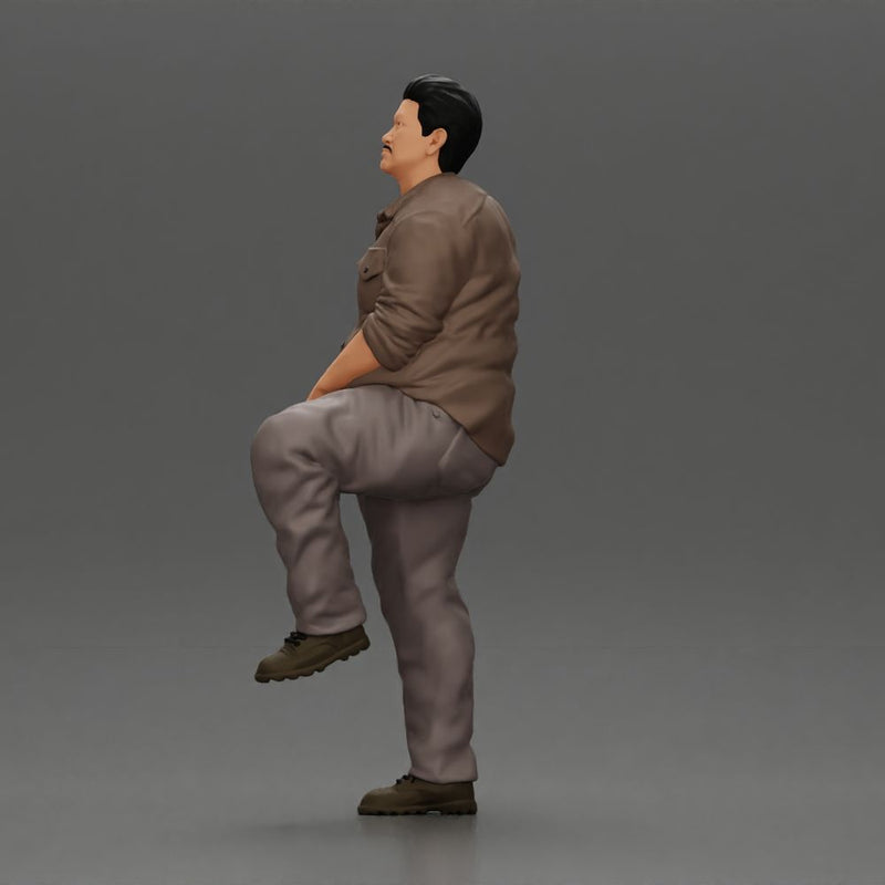 Fat Asian man looking upward in shirt and pants with one leg placed on a step