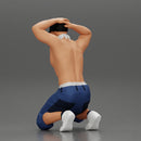 Gangster in mask and cap sitting putting his hands behind head about to be arrested - Only-Games