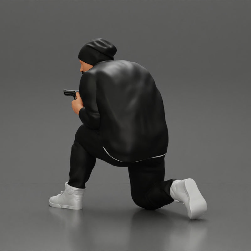 Gangster in hat and jacket sitting and holding a gun hides behind the car - Only-Games