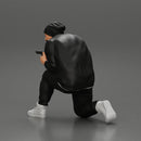 Gangster in hat and jacket sitting and holding a gun hides behind the car - Only-Games