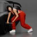 Girl mechanic in overalls turns off the front wheel of  car with a key for removing the wheel - Only-Games