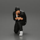 Gangster in hat and jacket sitting and holding a gun hides behind the car - Only-Games