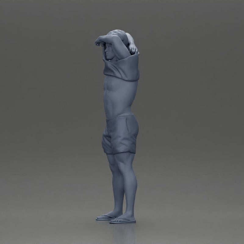 muscular man in shorts taking off his shirt to go swimming - Only-Games