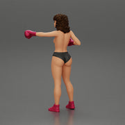 black naked breasts woman in boxing gloves with curly hair ready to finish off her opponent - Only-Games