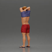 muscular man in shorts taking off his shirt to go swimming - Only-Games