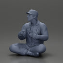 Jamie Farr sitting while eating breakfast in the MASH series - Only-Games