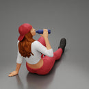 Tired woman mechanic in shirt pants and backwards cap sitting and drinking water during from bottle - Only-Games