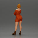 Woman in Orange Dress and Boots Stands Stylishly Confidence With Arms Crossed - Only-Games