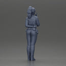 policewoman standing hand resting on her back speaking into a radio - Only-Games