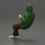 Man Sitting Wearing a Puffer Jacket, Holding a Coffee Cup - Only-Games