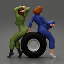 Two sexy girls in mechanic suits are sitting on a truck tire - Only-Games