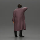 old man with pointed beard leaning against a wall in deep thought with his coat open - Only-Games