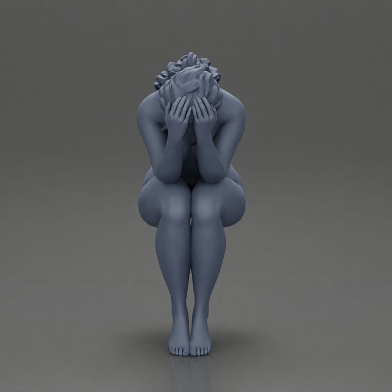 naked sad girl sitting and crying with her hands covering her face