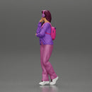 young woman listening to music with headphones and carrying a backpack - Only-Games