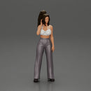 Stylish woman in a crop top and pants, standing thoughtfully - Only-Games