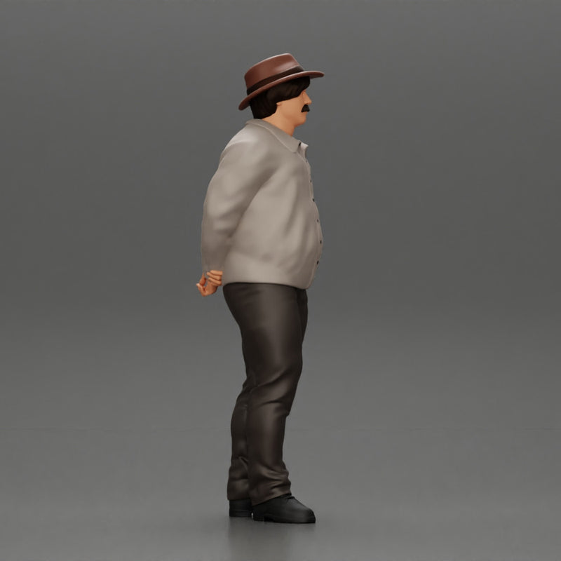 Man in a hat putting hands behind his back ( pablo escobar )