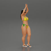 beautiful woman in a bikini with sunglasses standing with her arms raised up on the beach - Only-Games
