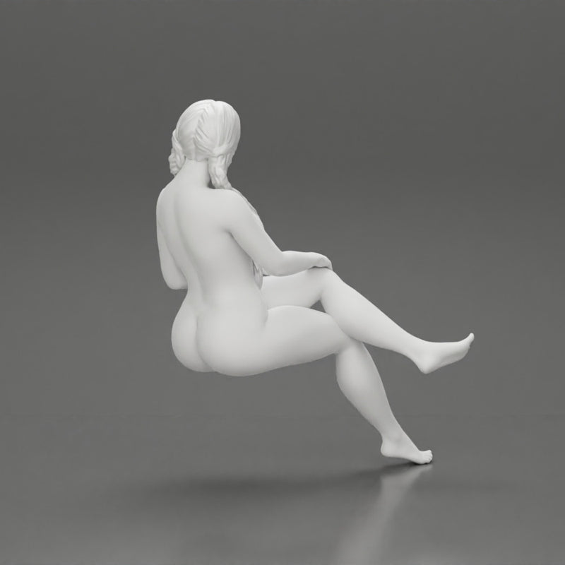 Naked girl sitting with crossed legs with long pigtails