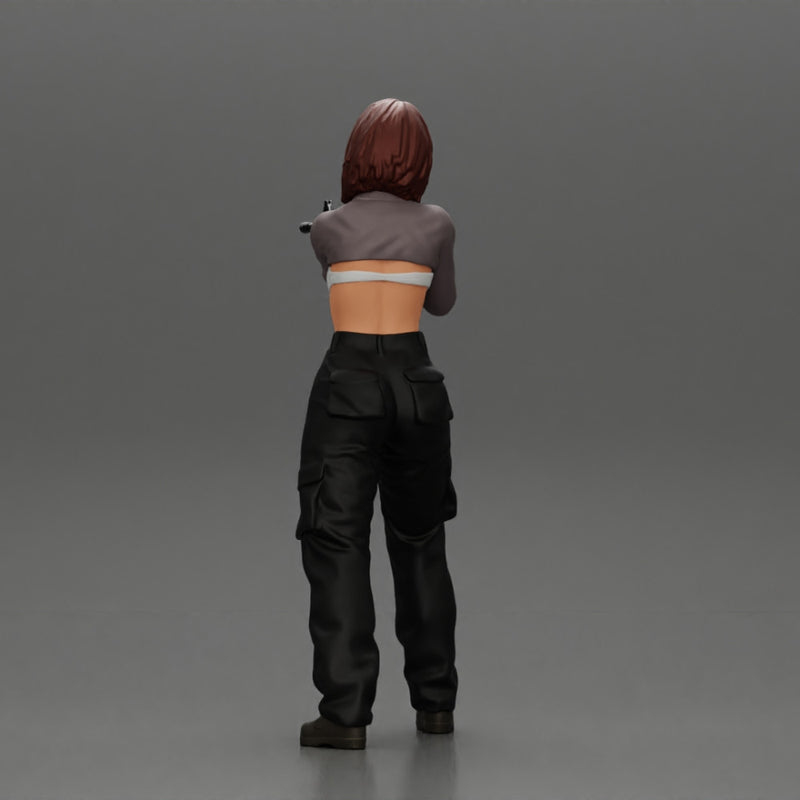 Armed girl going to shoot a gun in a bra with short hair