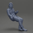 Man Sitting Wearing a Puffer Jacket, Holding a Coffee Cup - Only-Games