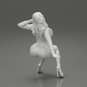 Young sexy girl in shorts with long hair is sitting with one hand in hair - Only-Games