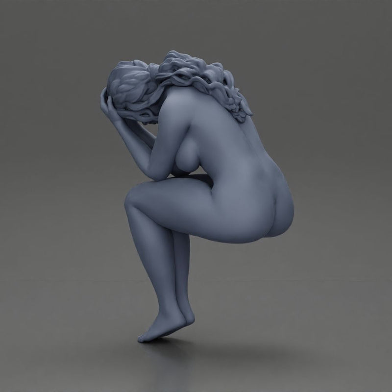 naked sad girl sitting and crying with her hands covering her face