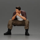 Thoughtful Man Squatting in Casual Outfit, Deep in Contemplation - Only-Games