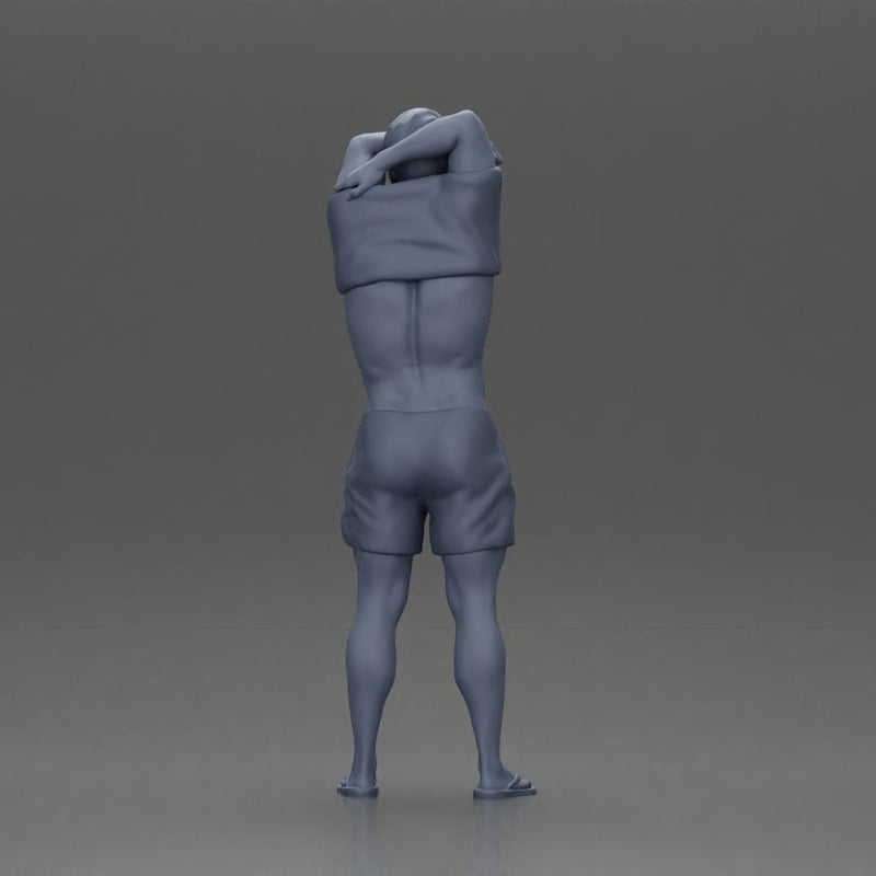 muscular man in shorts taking off his shirt to go swimming - Only-Games