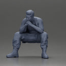 Thoughtful Man Squatting in Casual Outfit, Deep in Contemplation - Only-Games