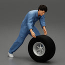 Mechanic worker walking and rolling tyre - Only-Games